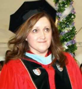 A Woman Proudly Wearing a Graduation Gown