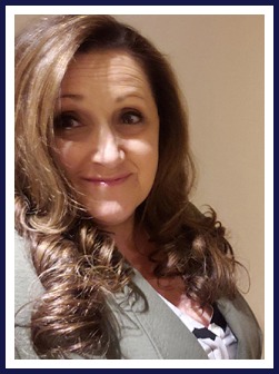 A Woman with Long Brown Hair Wearing a Green Jacket Stands Confidently